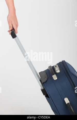 Suitcase being pulled along Stock Photo