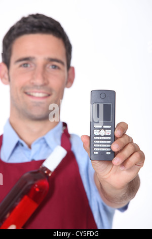 Waitor showing mobile phone Stock Photo