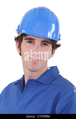 Man in blue overalls and hardhat Stock Photo