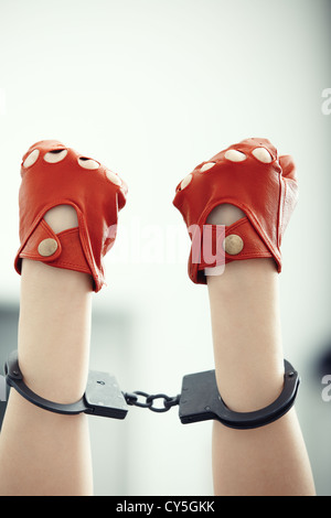 Two human hands in handcuffs. Vertical photo Stock Photo