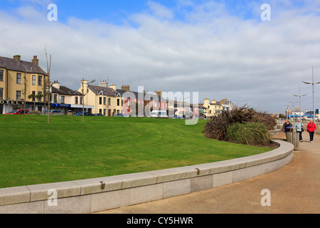 People walking on the seafront promenade of seaside resort on the east coast at Newcastle, Co Down, Northern Ireland, UK Stock Photo