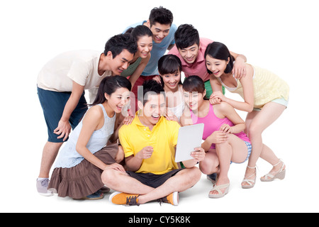 Happy young friends sharing a digital tablet Stock Photo