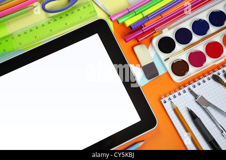 Concept of online education. Tablet pc with school and office supplies Stock Photo