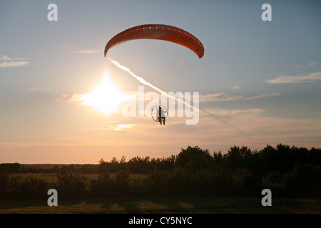 Powered paraglider flies over Marsden, Saskatchewan Stock Photo