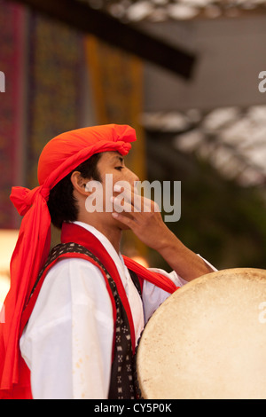 A male dancer performs a traditional Okinawan dance at Ryukyu Village - a theme park dedicated to ancient Okinawan culture. Stock Photo