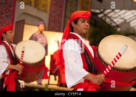 A male dancer performs a traditional Okinawan dance at Ryukyu Village - a theme park dedicated to ancient Okinawan culture. Stock Photo