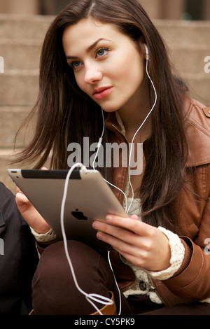 Beautiful young woman using Skype application on her ipad Stock Photo
