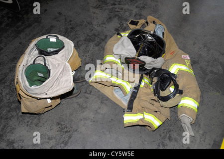 firefighters gear sits on the floor waiting to be used when a call comes in Stock Photo