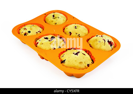 Six cupcakes with berries in orange silicone mold isolated on white background Stock Photo
