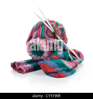 Multi colored socks, knitting needle and wool ball on white background Stock Photo