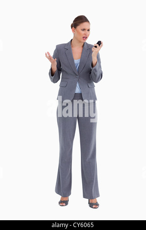 Confused tradeswoman looking at her cellphone Stock Photo