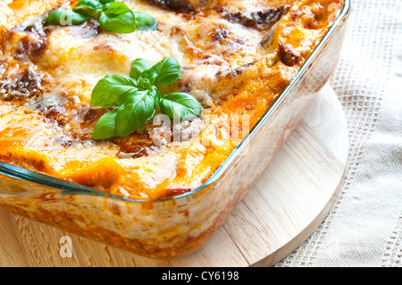 Freshly baked lasagne with fresh basil on top Stock Photo