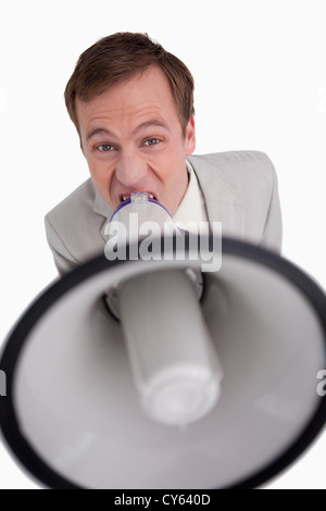 Businessman shouting through megaphone Stock Photo