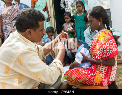 Indian baby hair cutting ritual / puja in a rural indian village. Andhra Pradesh. India Stock Photo