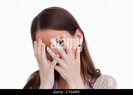 Close up of woman hiding behind her hands Stock Photo
