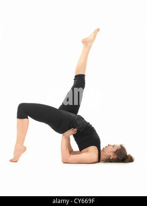 young Caucasian woman in balancing yoga pose Stock Photo