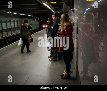 People waiting for train at Hillhead underground station in Glasgow's west end. Stock Photo