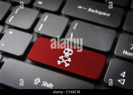 Internet business security concept: red key with skull icon on laptop keyboard. Included clipping path, so you can easily edit it. Stock Photo