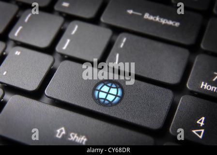 Internet global business concept: key with bright World icon on laptop keyboard. Included clipping path, so you can easily edit it. Stock Photo