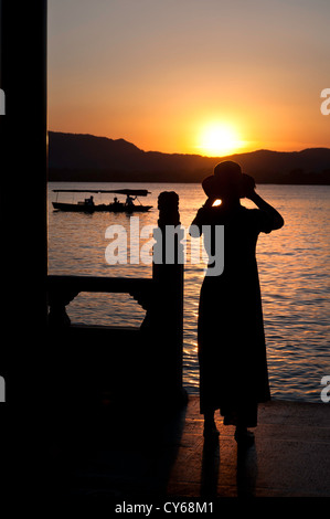 Woman photographing the sunset, West Lake, Hangzhou Stock Photo