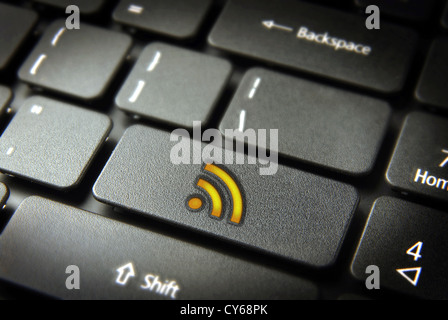 Golden technology RSS icon key on laptop keyboard. Included clipping path, so you can easily edit it. Stock Photo