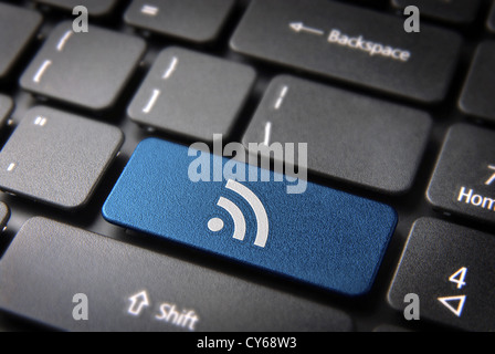 Blue technology key with RSS icon on laptop keyboard. Included clipping path, so you can easily edit it. Stock Photo