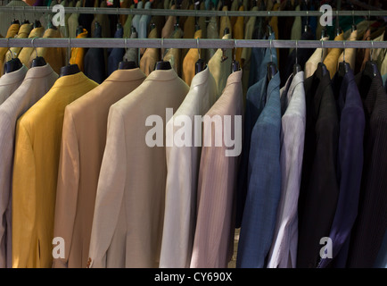 colorful male suits in row in a hanger as a pattern Stock Photo