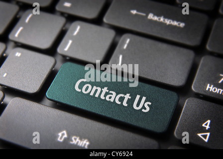 Website template section key with Contact us text on laptop keyboard. Included clipping path, so you can easily edit it. Stock Photo