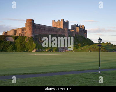 Dusk at Bamburgh Castle, situated on the Northeast coast of Northumberland just outside the town of Bamburgh Stock Photo