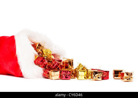 small colorful christmas presents falling from santas hat on white background Stock Photo