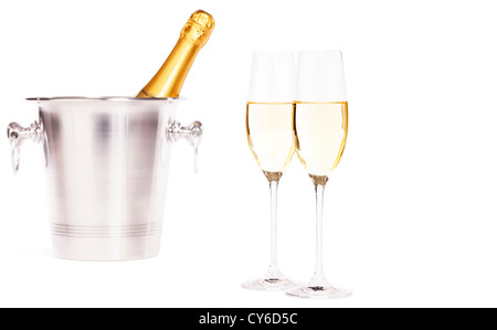 two glasses of champagne with a champagne bottle in a bucket on white background Stock Photo