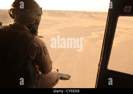 U.S. Marine Corps Cpl. Roberto Guerrero, UH-1Y Venom door gunner, with the air interdiction force (AIF) assigned to Marine Light Attack Helicopter Squadron (HMLA) 469, Marine Aircraft Group 39, 3rd Marine Aircraft Wing (Forward), conducts Operation Aero Hunter with other Regional Command (Southwest) elements in Helmand province, Afghanistan, Oct. 24, 2012. AIF was used as a quick reaction force in support of counter-insurgency operations in southern Helmand Stock Photo