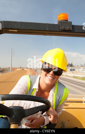 Ali Walker drives a large road rolling machine at the Syncrude Mildred Lake tar sands plant Stock Photo