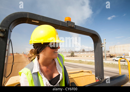 Ali Walker drives a large road rolling machine at the Syncrude Mildred Lake tar sands plant Stock Photo