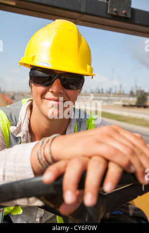 Ali Walker drives a large road rolling machine at the Syncrude Mildred Lake tar sands plant Stock Photo