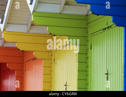 Row of colorful wooden beach chalets. Stock Photo