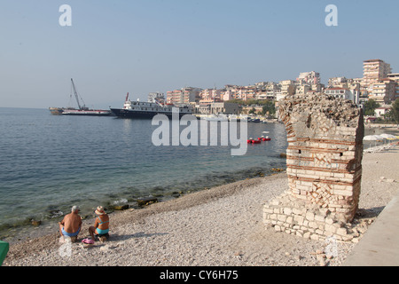 The Beach at Saranda in Albania with Tourists and Roman Ruins Stock Photo