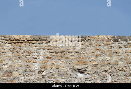 Horizontal old brick wall with blue sky background and copy space. Stock Photo