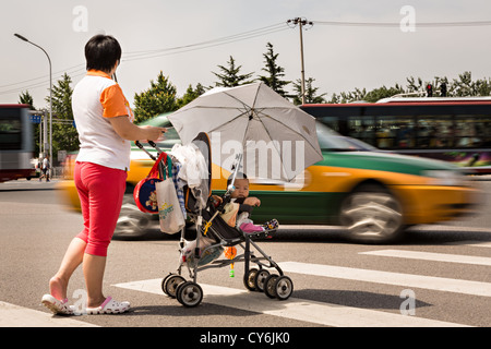 Woman Pushing Baby Stroller During Winter Stock Photo Alamy