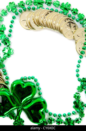 St. Patrick's day border including green shamrock and gold coins on a white background Stock Photo