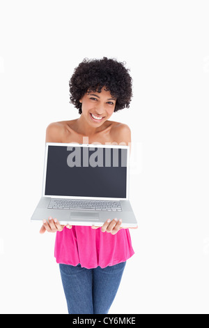 Smiling and beautiful teenager holding her laptop Stock Photo