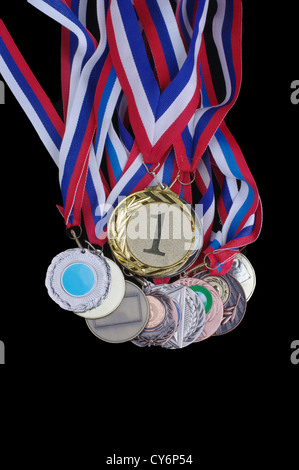 Many gold, silver, and bronze medals isolated on black background Stock Photo