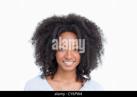 Young woman with curly hair standing upright Stock Photo