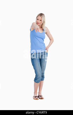 Relaxed blonde woman pointing her finger Stock Photo