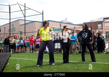 First Lady Michelle Obama dances during a Flash Mob Dance at Alice Deal Middle School May 3, 2011 in Washington, DC. Stock Photo