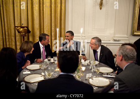 US President Barack Obama talks with House Minority Leader Nancy Pelosi, House Speaker John Boehner, and Senate Majority Leader Harry Reid during a dinner with chairmen and ranking Members of Congress May 2, 2011 in the East Room of the White House. Stock Photo