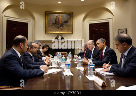 US President Barack Obama drops by a meeting between National Security Advisor Tom Donilon and Crown Prince Salman of Bahrain, second from left June 7, 2011 in the Roosevelt Room of the White House. Stock Photo