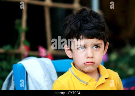Offended boy looking away from camera Stock Photo