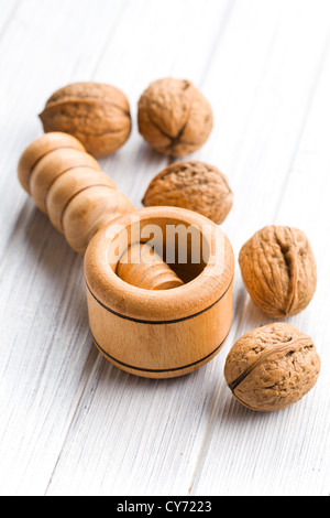 wooden nutcracker and walnuts on kitchen table Stock Photo