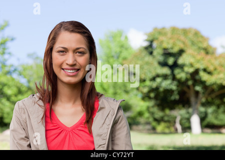 Young woman looking straight ahead with a smile on her face Stock Photo